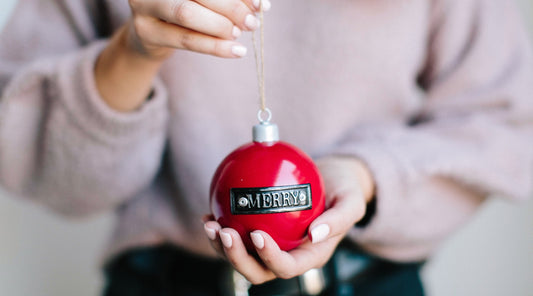 woman holding Christmas ornament in her hand templeton silver - Christmas Gift Ideas For Any Girl On Your List!