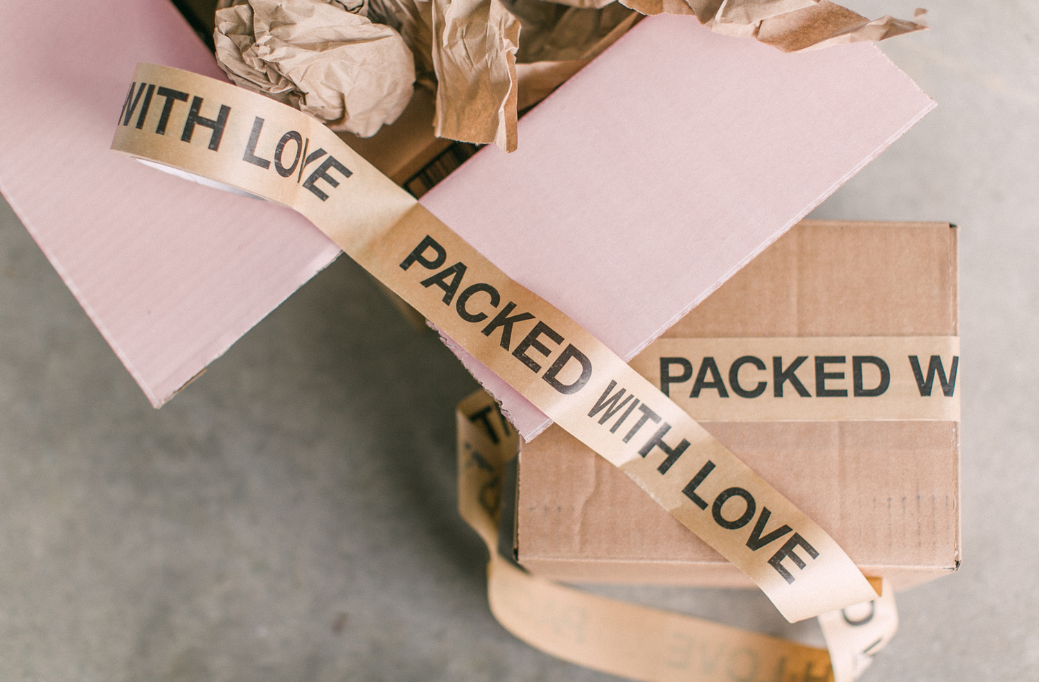 boxes with packing tape on them that say packed with love