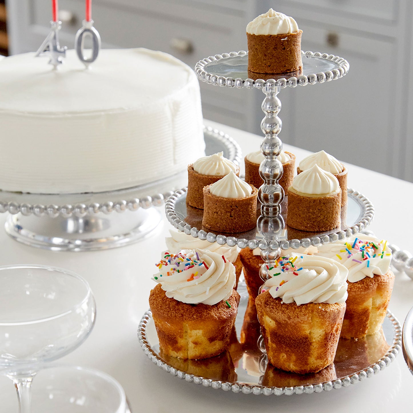 Silver Number Candle Holder Set (For Cake) on a cake and cupcakes on a cake stand