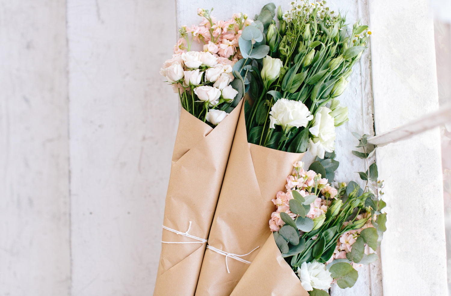 beautiful flowers wrapped in brown paper and tied with a bow - contact us