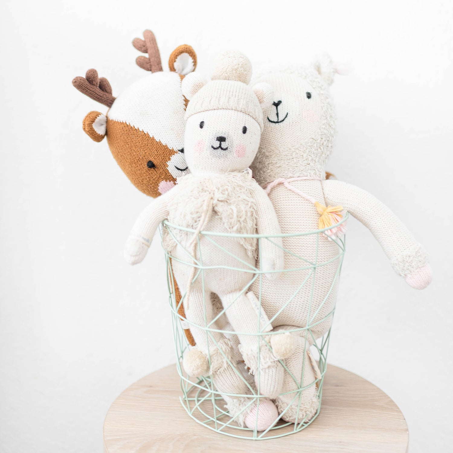 stuffed animals in a wire basket