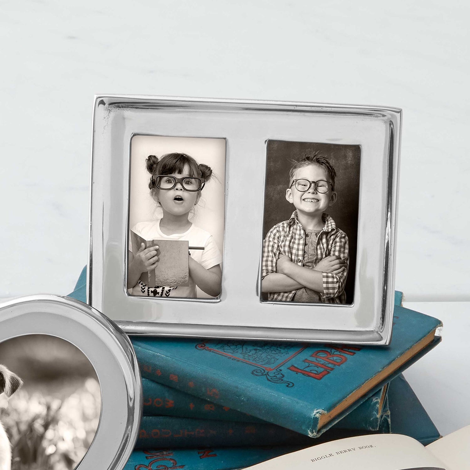 silver frames on top of books