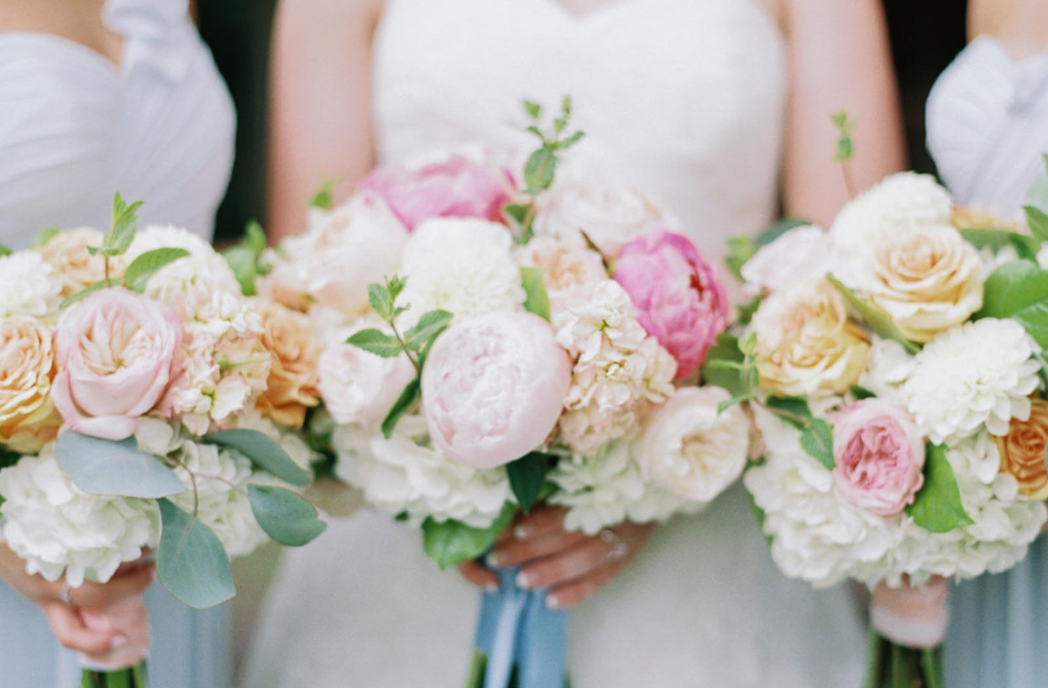 bridesmaid's gifts - bridesmaids and bride with gorgeous bouquets of flowers